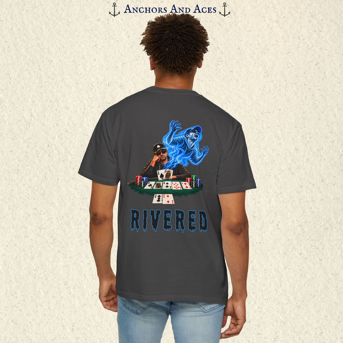 Model wearing RIVERED Texas Hold'em poker graphic tee back view featuring a player at a poker table with playing cards, poker chips, and an electric blue soul rising from his body after a bad beat on the river. Comfort Colors 1717