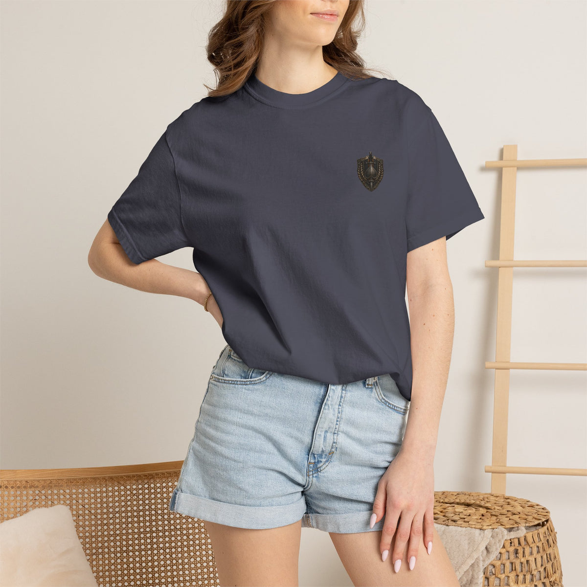 Front view of House of Spades playing card shirt on a female model with small medieval-inspired crest emblem.