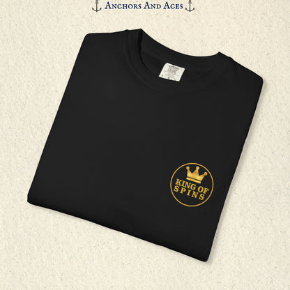 Folded Black Slot King T-shirt showing the small gold King of Spins chest emblem.