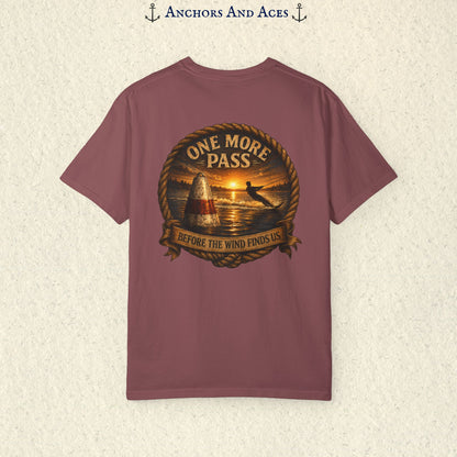 Brick red vintage slalom water ski T-shirt shown from the back with a sunrise lake graphic featuring a slalom buoy, water skier, rope border, and the text One More Pass and Before the Wind Finds Us.