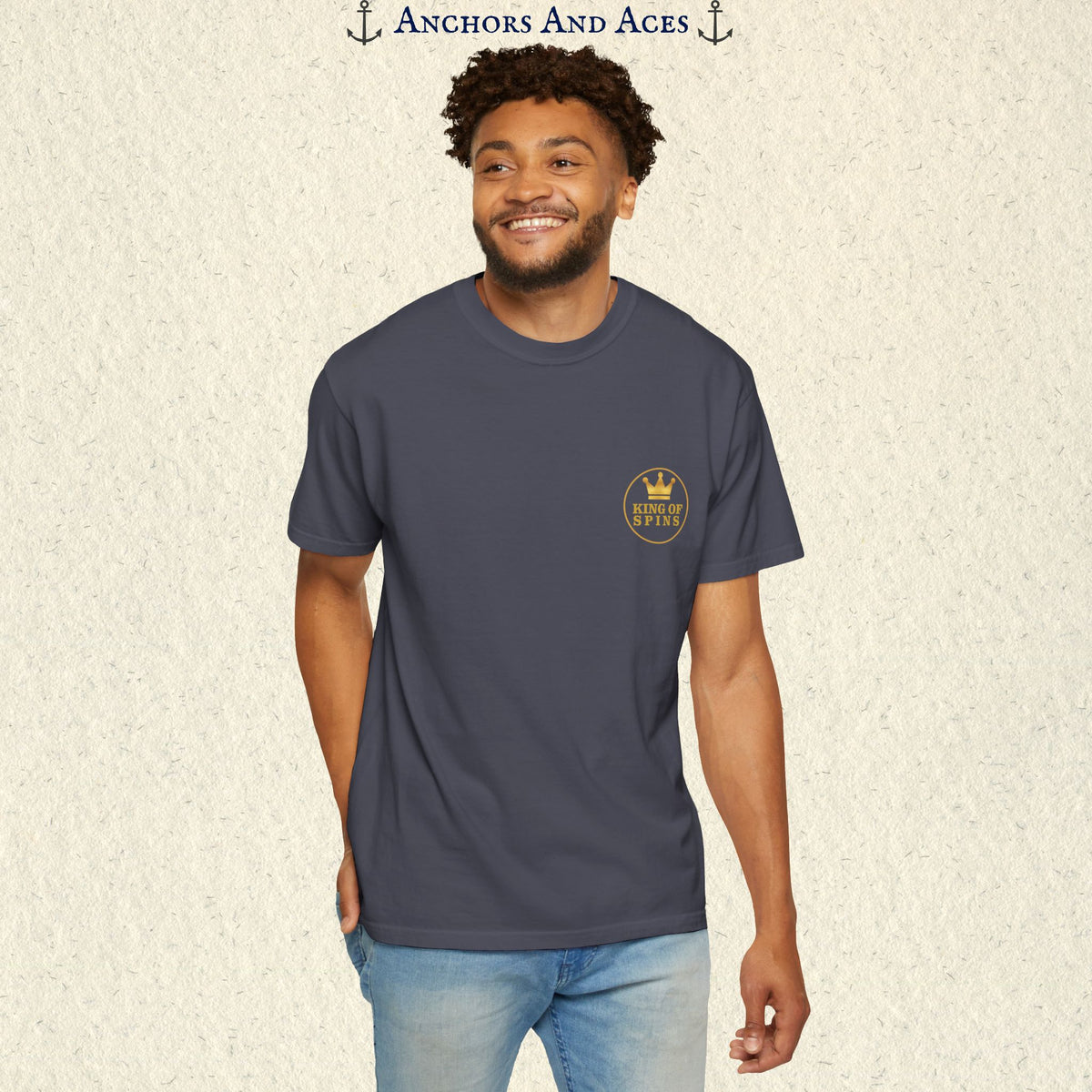 Man wearing a Navy Slot King T-shirt with the small gold King of Spins emblem on the front.