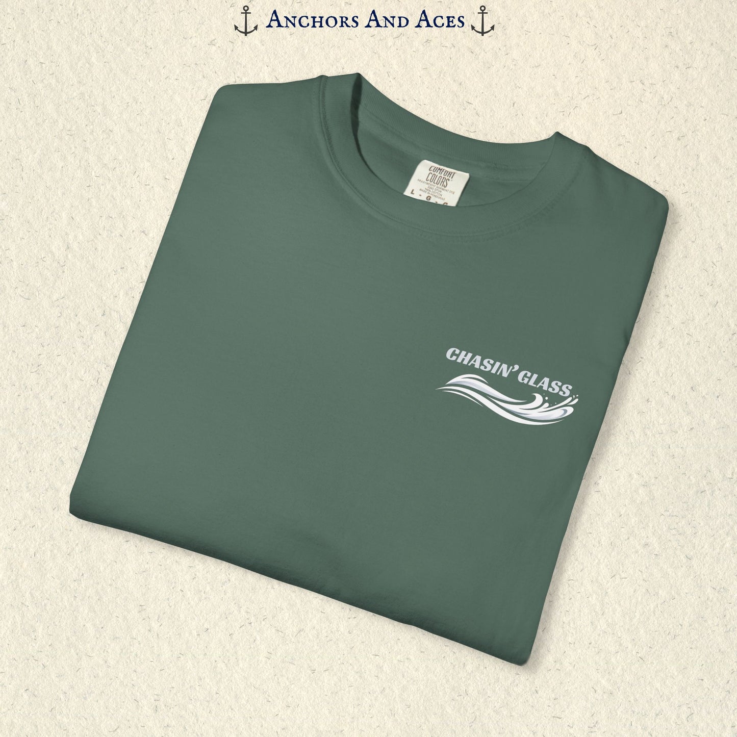 Folded Blue Spruce T-shirt showing the small white Chasin' Glass water splash logo on the left chest.
