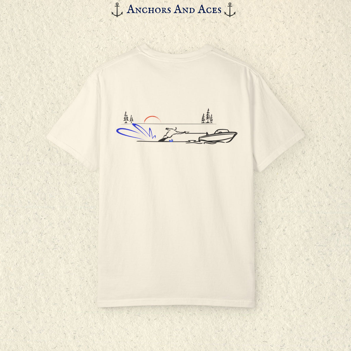Ivory Comfort Colors 1717 water ski shirt shown from the back, featuring minimalist line art of a ski boat pulling a slalom water skier across calm lake water at sunrise with pine trees and blue spray.