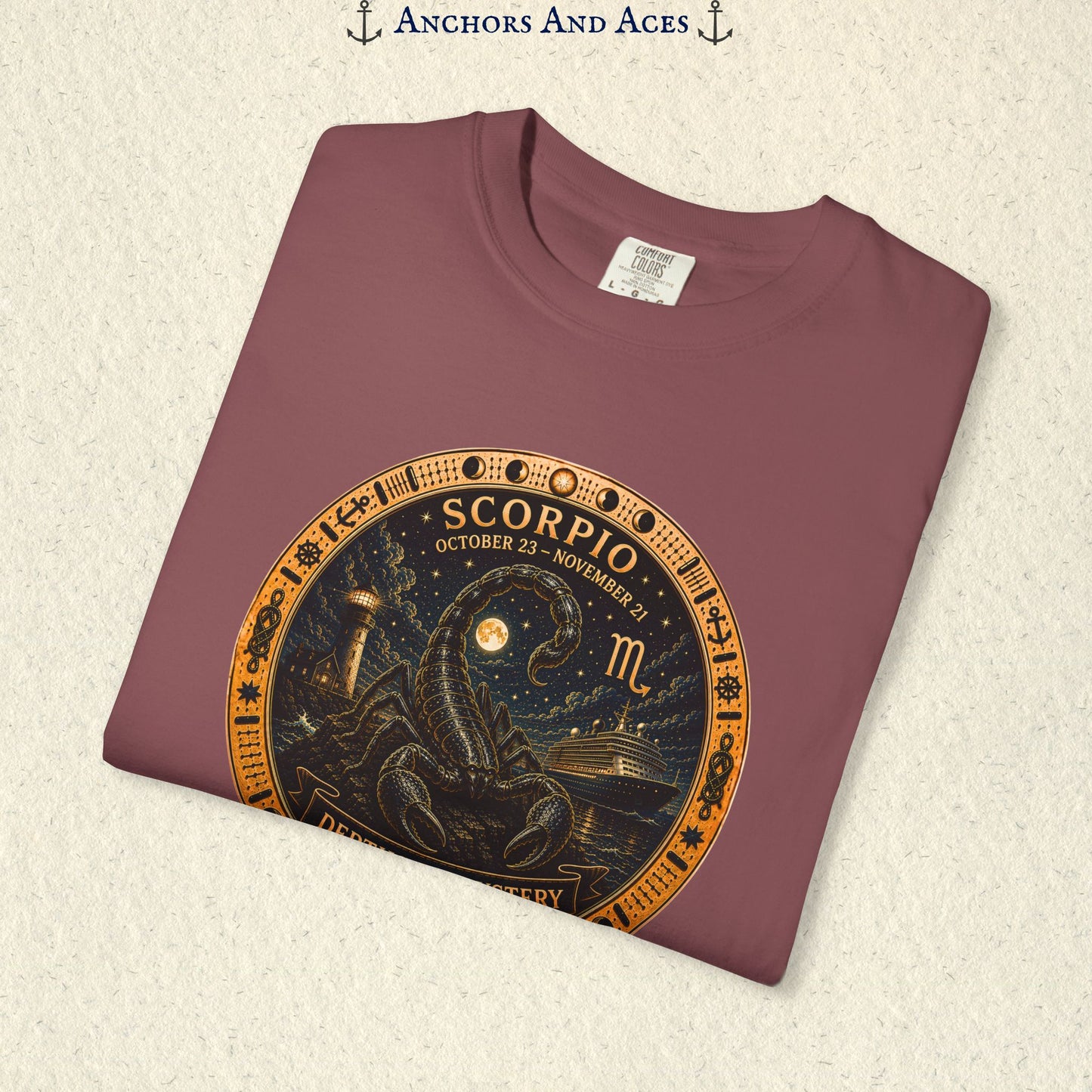 Folded Scorpio zodiac shirt close-up showing scorpion celestial medallion and Depths of Mystery artwork