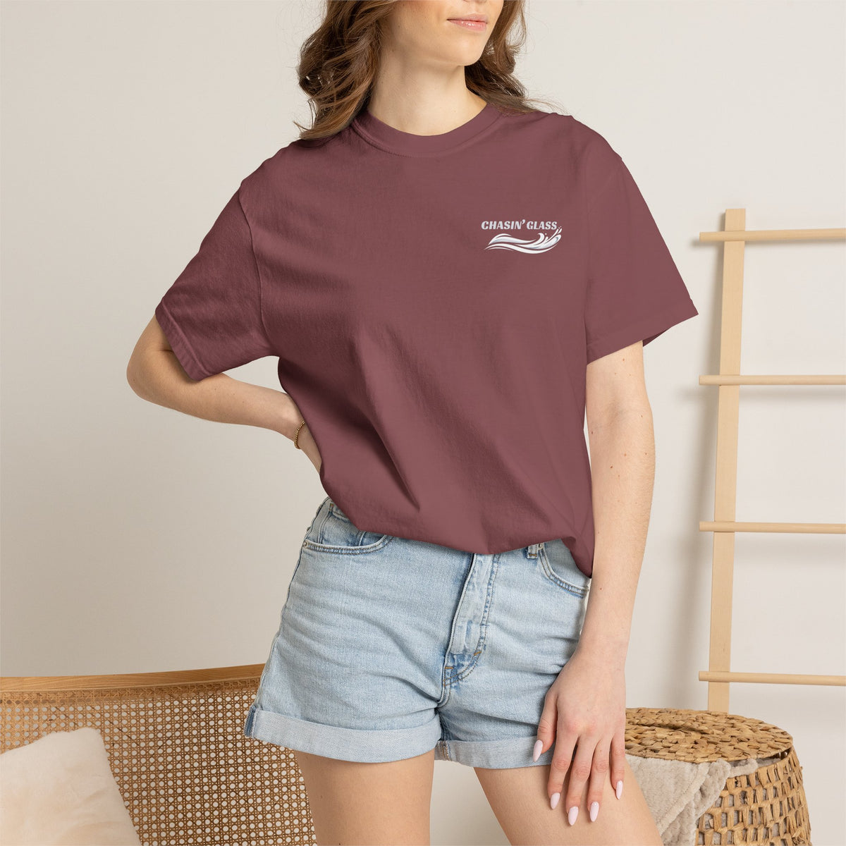 Model wearing a Brick Comfort Colors 1717 water ski t-shirt from the front, showing the small white Chasin' Glass water-splash logo on the left chest.
