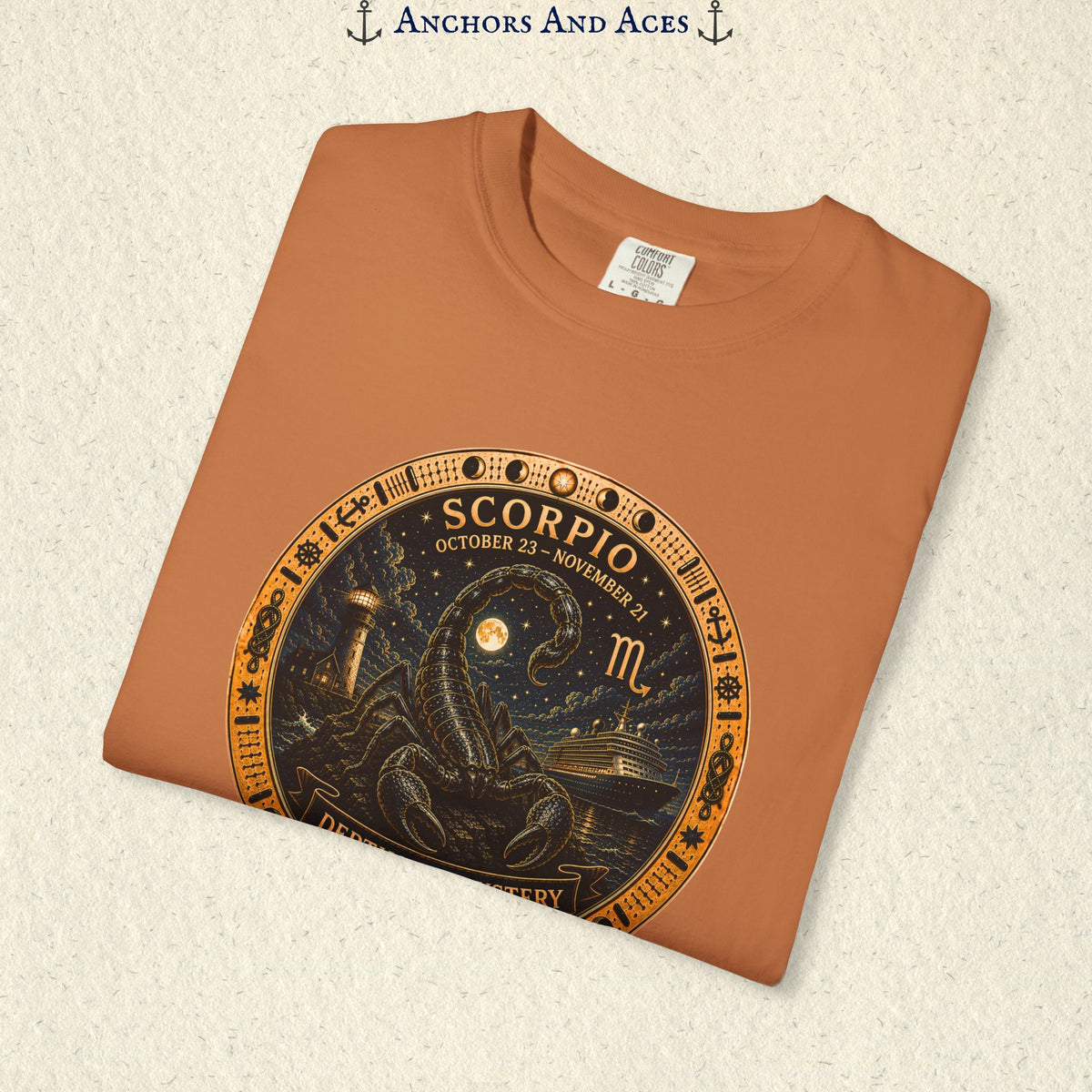 Folded Scorpio zodiac shirt close-up showing scorpion celestial medallion and Depths of Mystery artwork