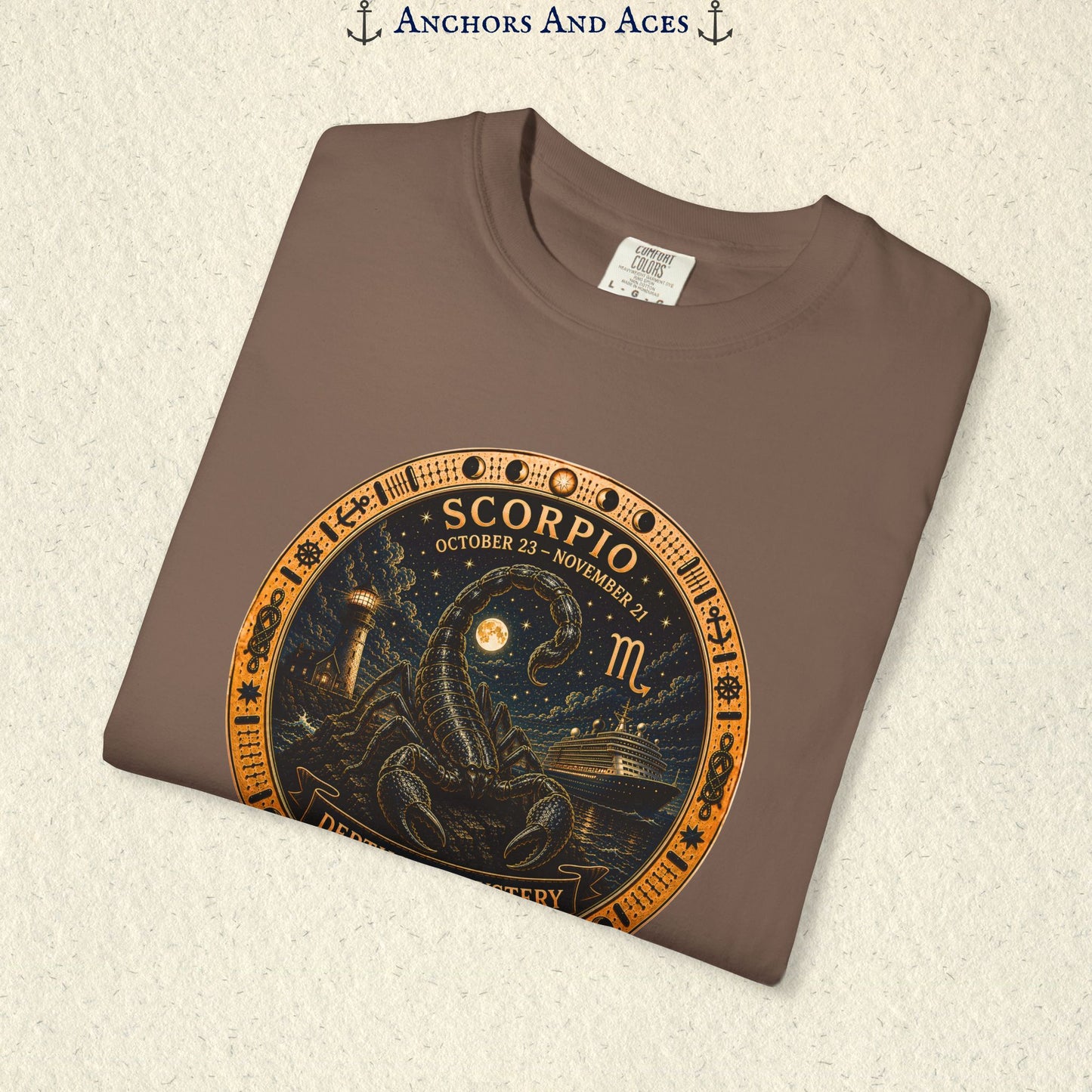 Folded Scorpio zodiac shirt close-up showing scorpion celestial medallion and Depths of Mystery artwork