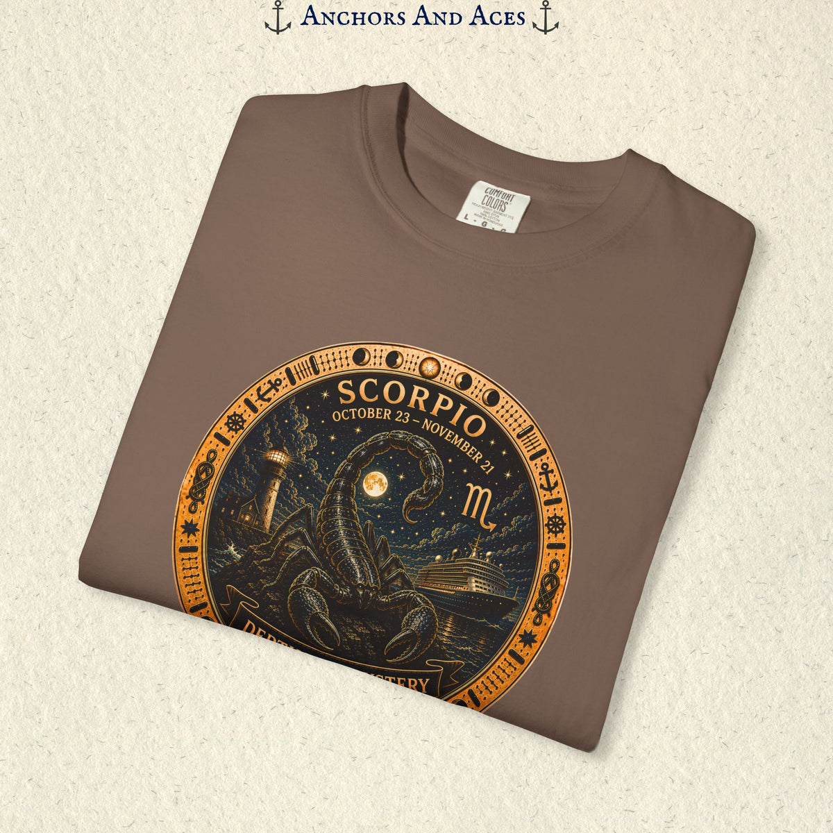 Folded Scorpio zodiac shirt close-up showing scorpion celestial medallion and Depths of Mystery artwork