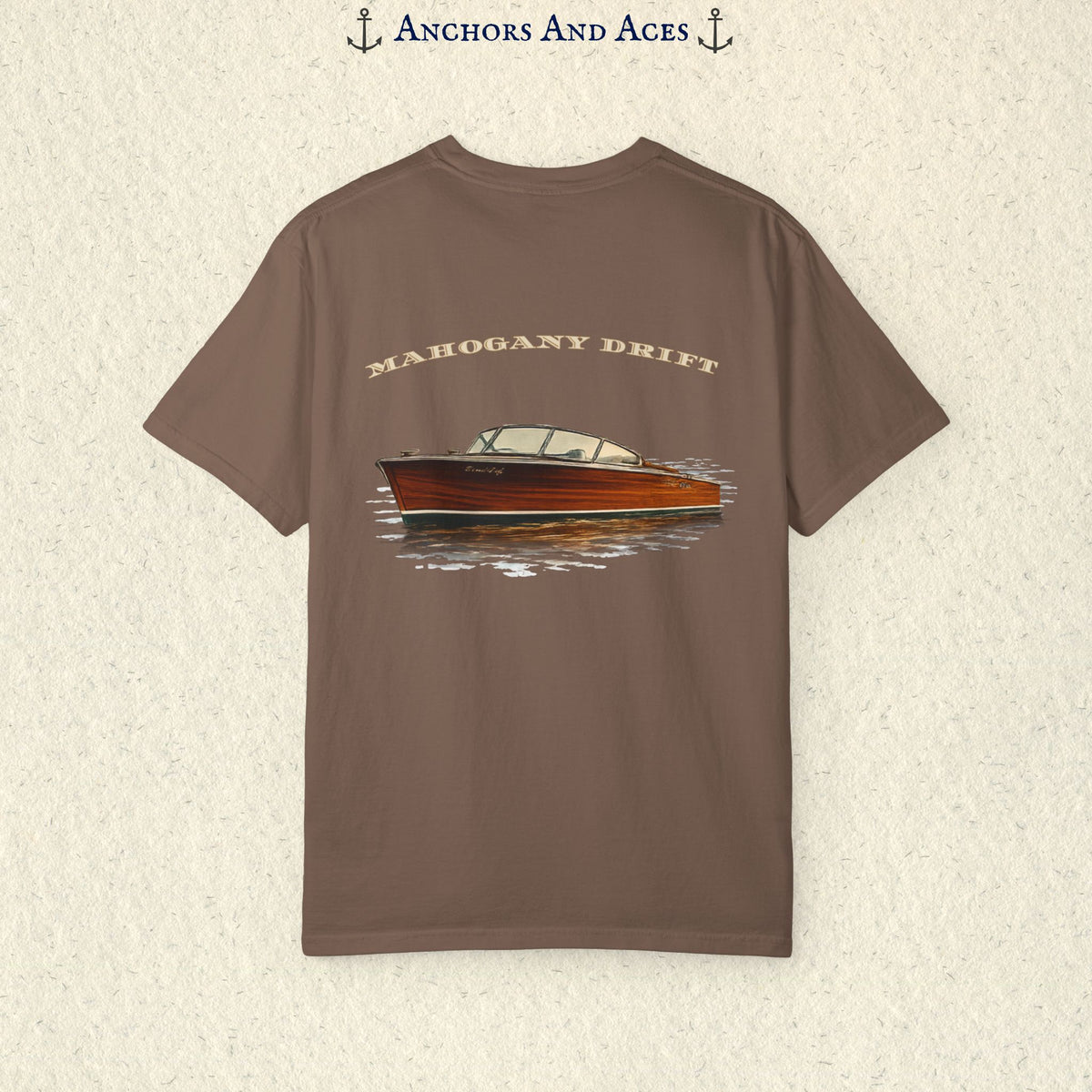 Brown vintage wooden boat T-shirt with Mahogany Drift text and classic mahogany runabout graphic on glass-calm water.