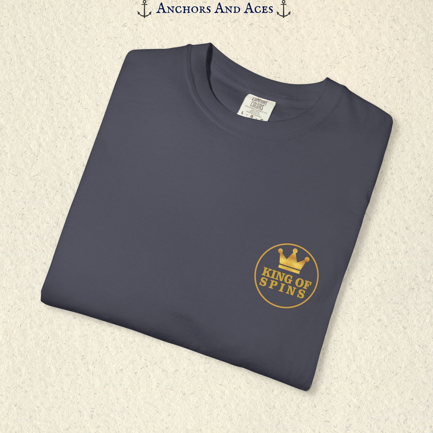 Folded Navy Slot King T-shirt showing the small gold King of Spins chest emblem.