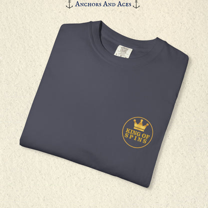 Folded Navy Slot King T-shirt showing the small gold King of Spins chest emblem.