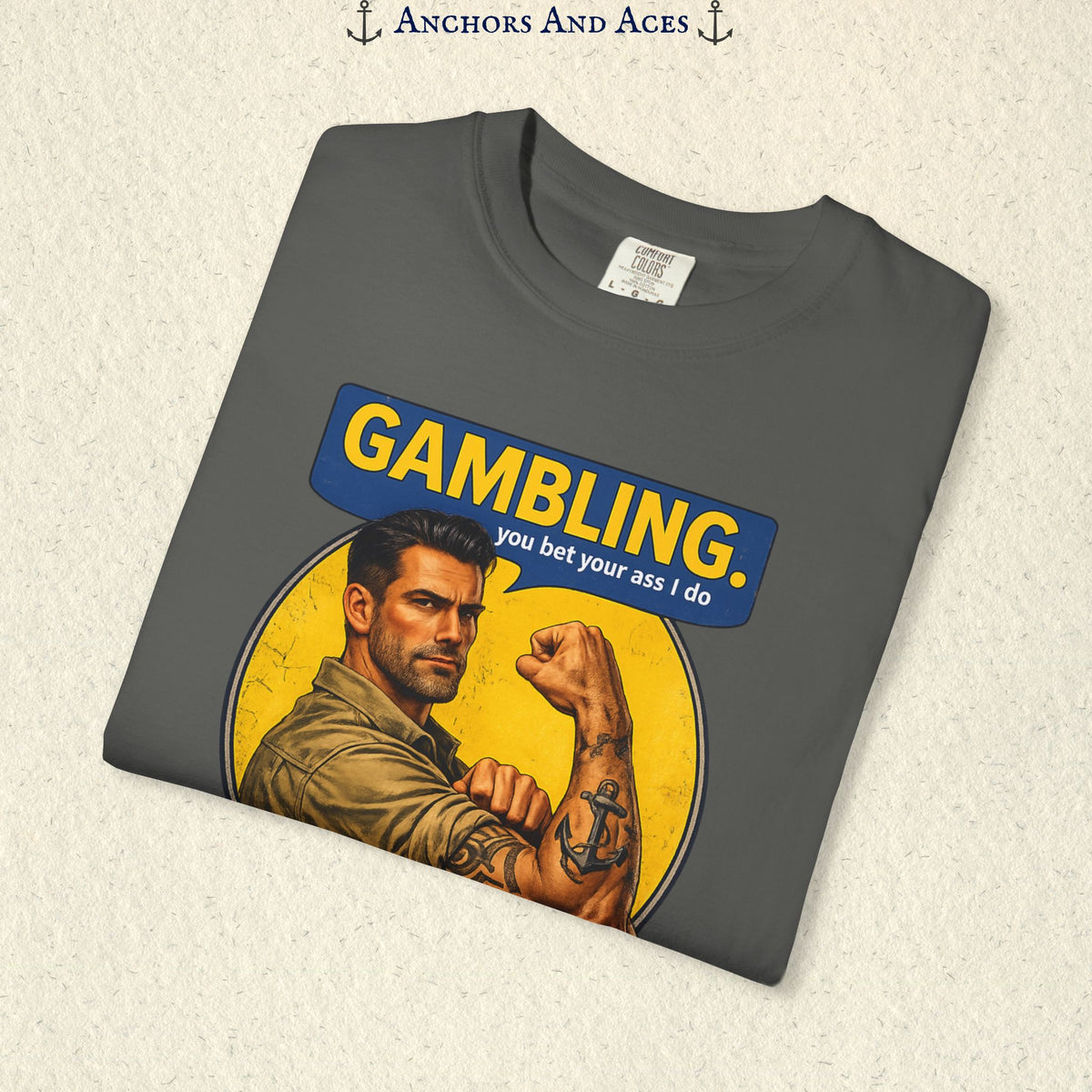 Folded Graphite funny gambling T-shirt showing the retro strongman flexing beneath bold GAMBLING text.