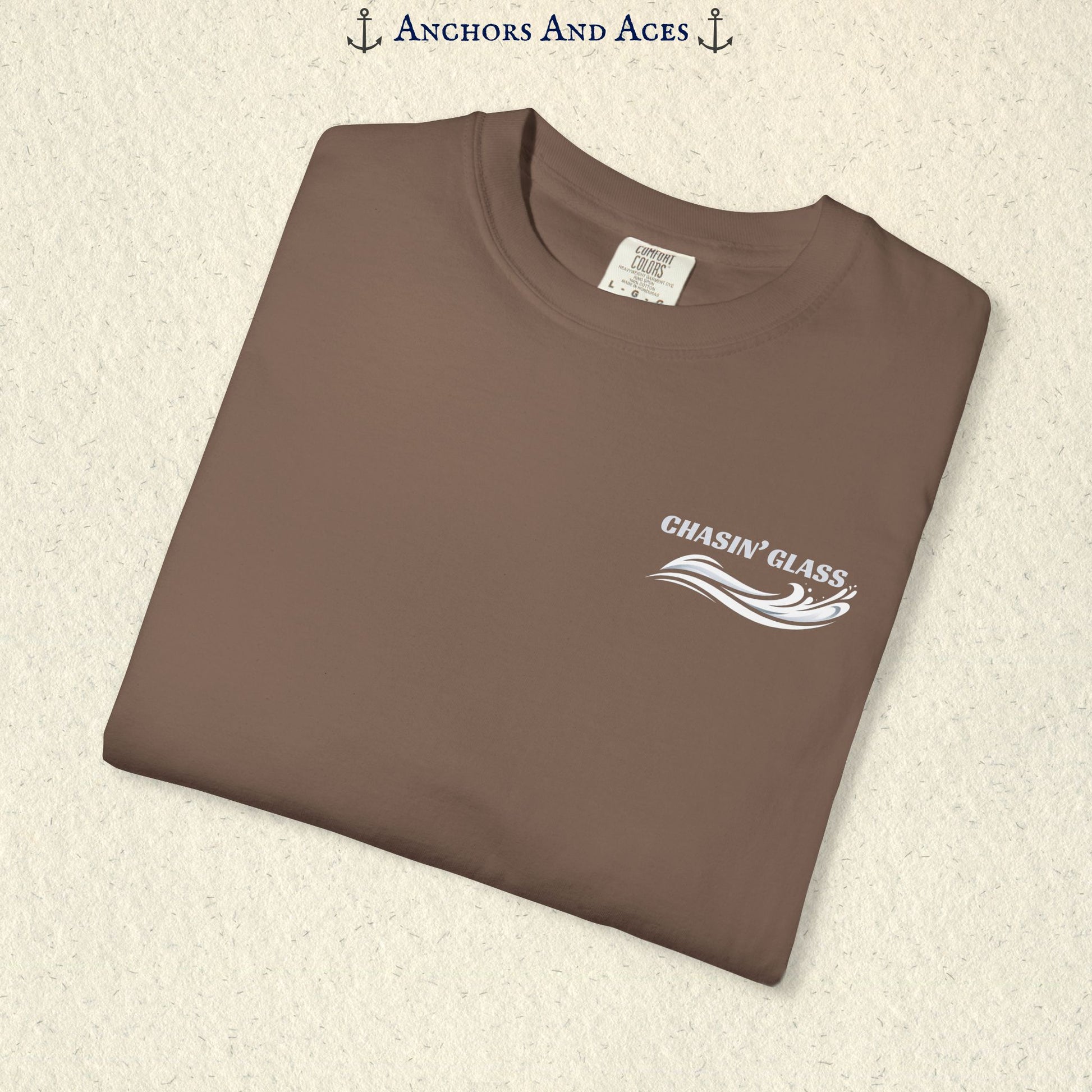 Folded Espresso T-shirt showing the small white Chasin' Glass water splash logo on the left chest.