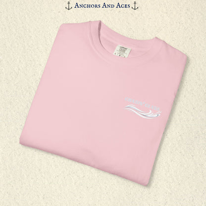 Folded Blossom Comfort Colors 1717 t-shirt showing the front left-chest Chasin' Glass logo, featuring white lettering above a stylized water-splash graphic.