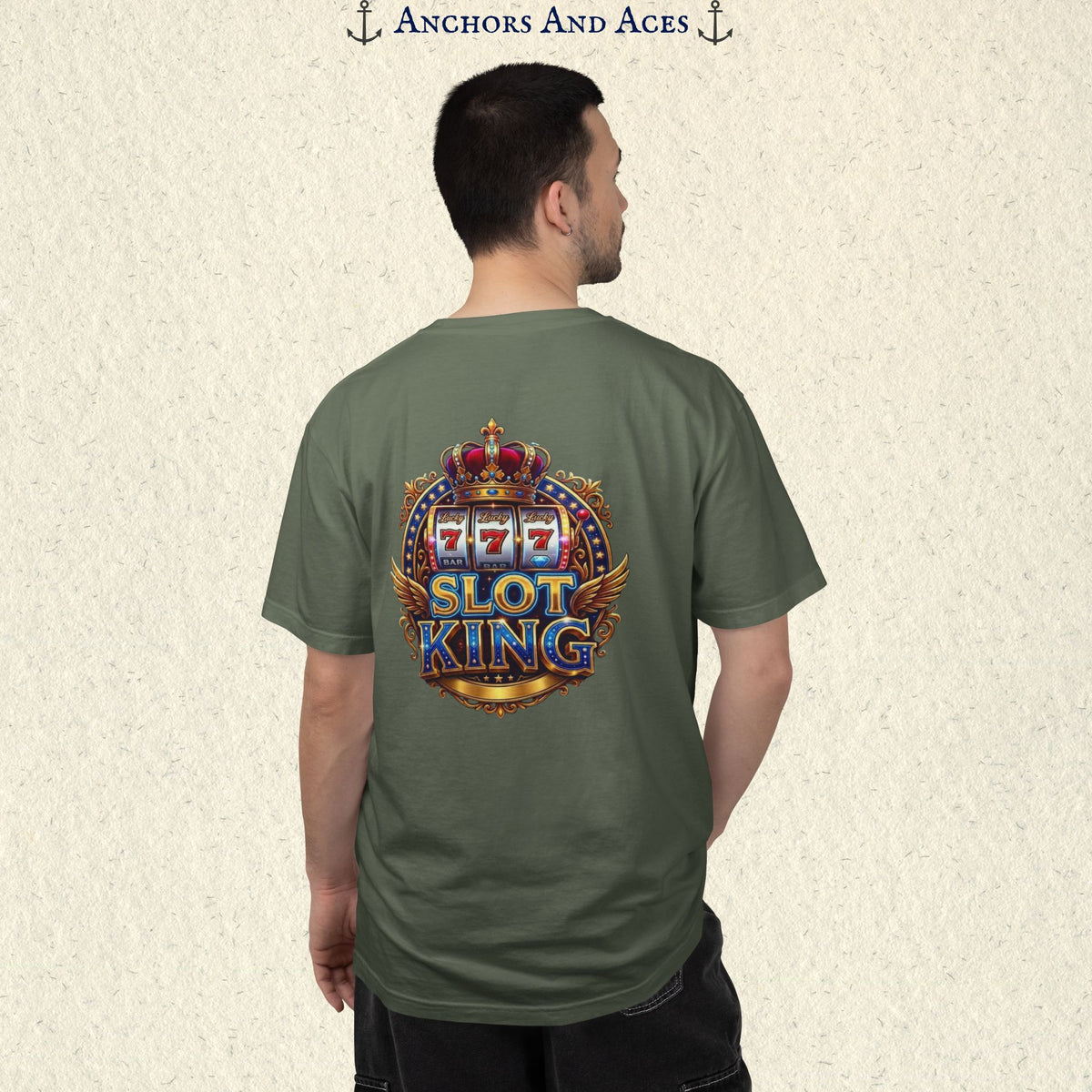 Man wearing a Moss Slot King T-shirt with the crowned 777 slot machine artwork on the back.