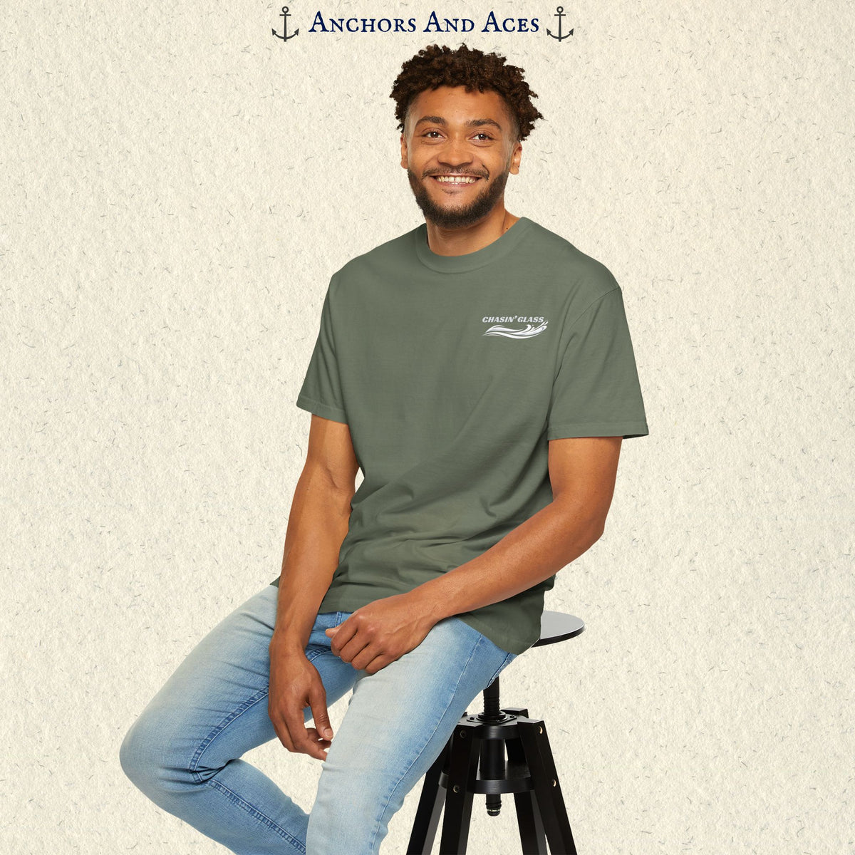 Model wearing a Moss green vintage water ski T-shirt, front view, with the small white Chasin' Glass text and stylized water splash logo on the left chest.