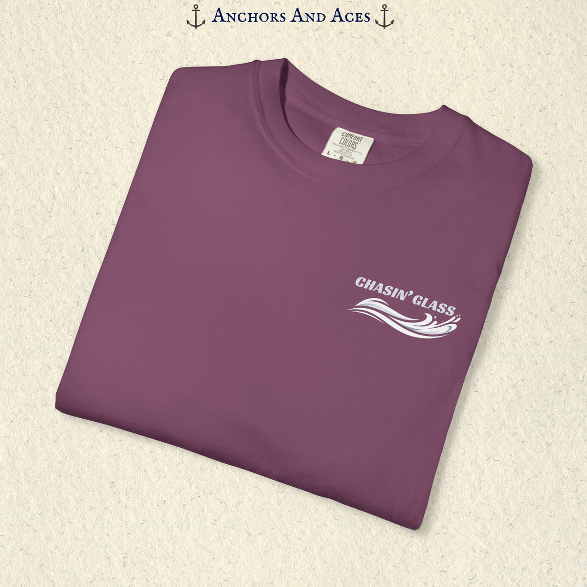 Folded Berry purple T-shirt showing the small white Chasin' Glass text and stylized water splash logo on the left chest.