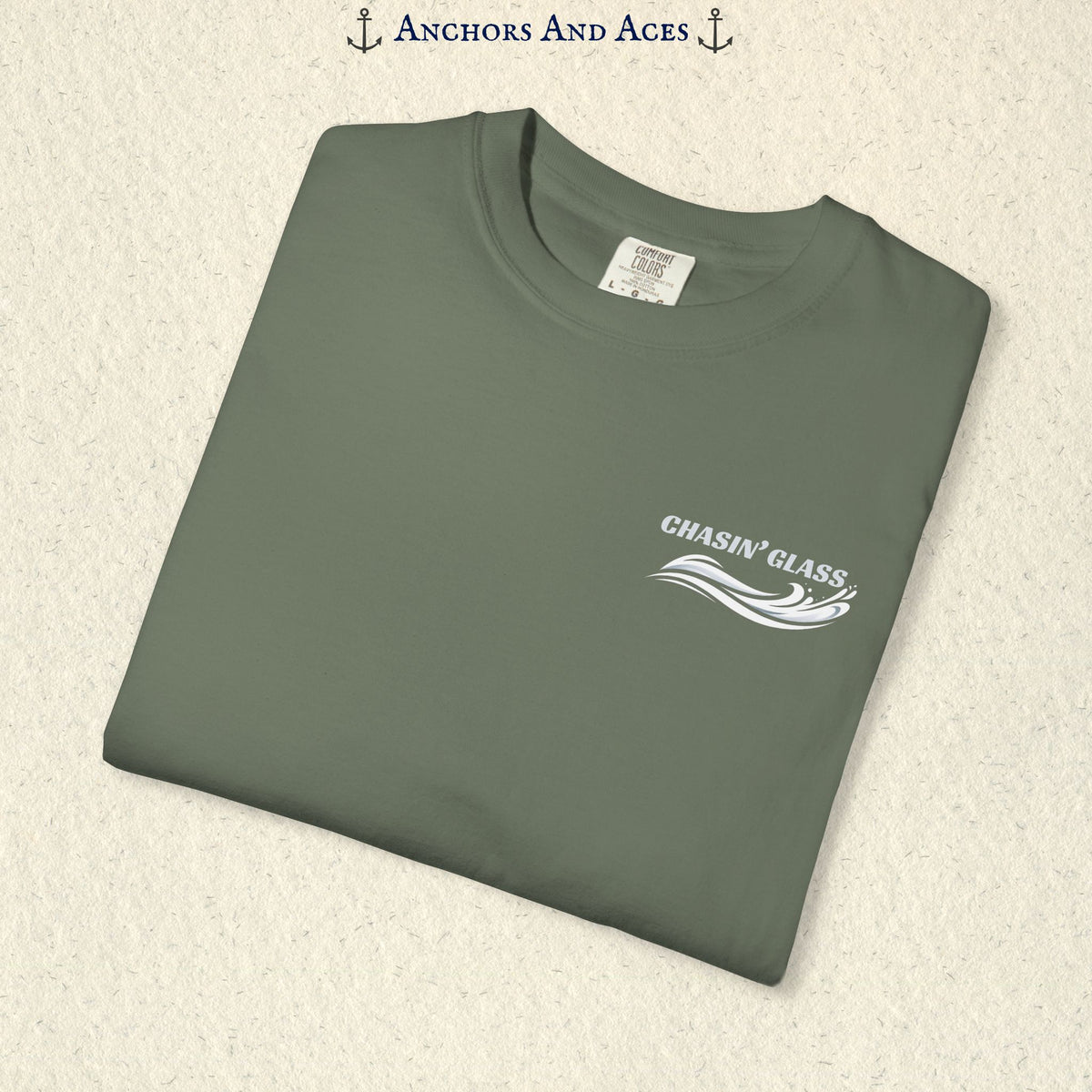 Folded Moss green T-shirt showing the small white Chasin' Glass text and stylized water splash logo on the left chest.