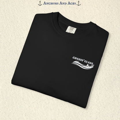 Folded black T-shirt showing the small white Chasin' Glass text and stylized water splash logo on the left chest.