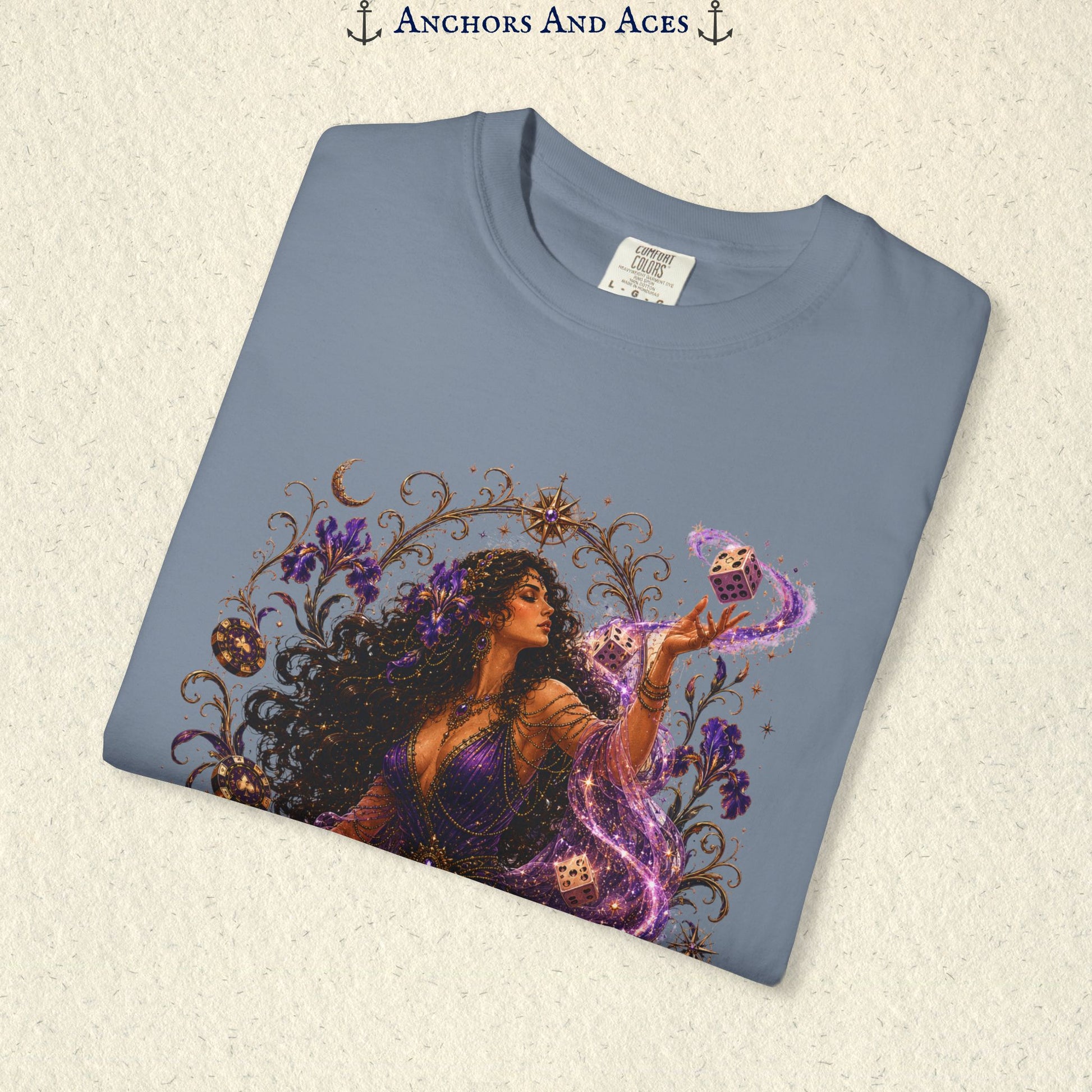 Close-up of Goddess of Chance Art Nouveau graphic on Blue Jean Comfort Colors tee with illustrated goddess, dice, irises, and gold filigree.
