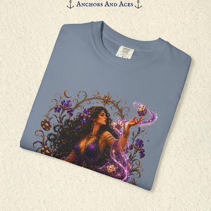 Close-up of Goddess of Chance Art Nouveau graphic on Blue Jean Comfort Colors tee with illustrated goddess, dice, irises, and gold filigree.