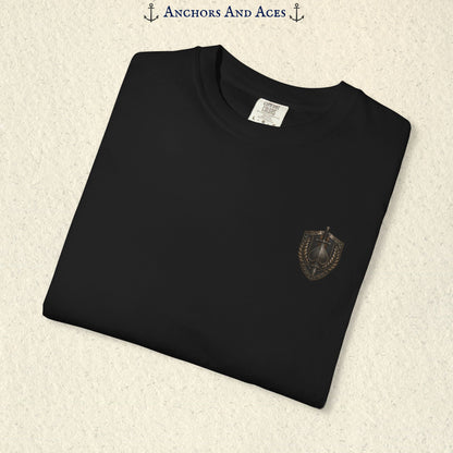 Folded House of Spades graphic tee showing the small medieval-inspired heraldic crest emblem on the front.