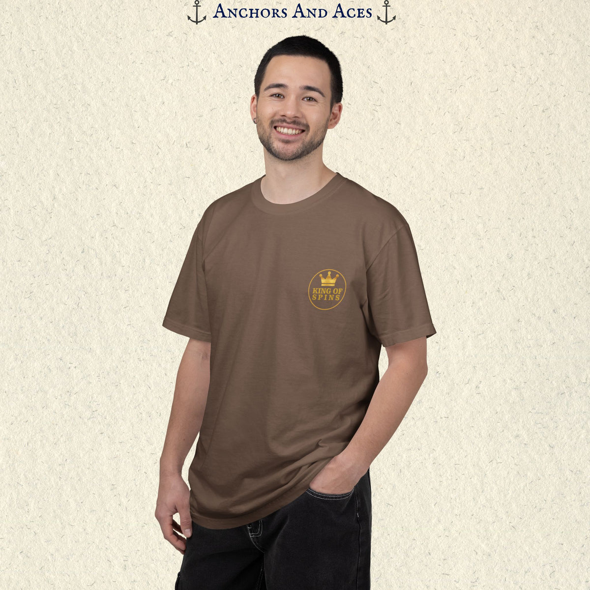 Man wearing an Espresso Slot King T-shirt with the small gold King of Spins emblem on the front.