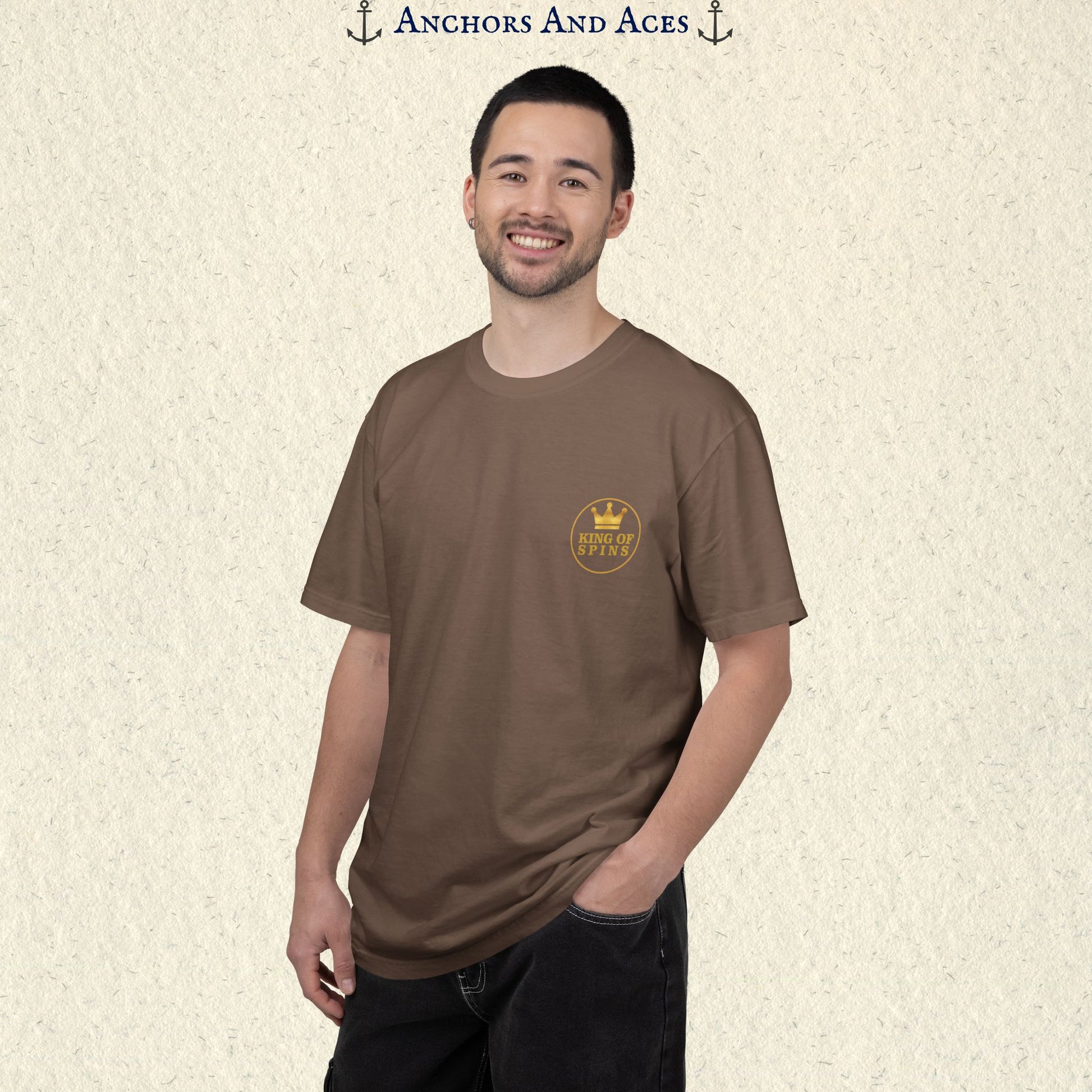 Man wearing an Espresso Slot King T-shirt with the small gold King of Spins emblem on the front.