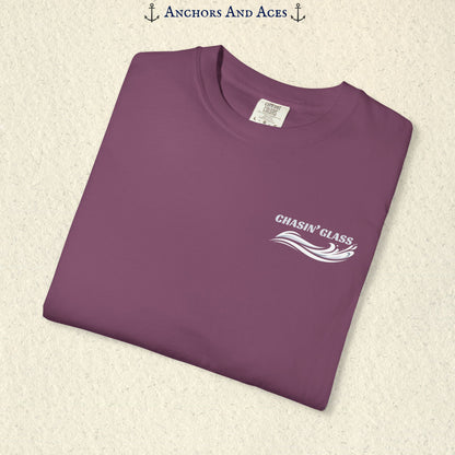 Folded Berry Comfort Colors 1717 t-shirt showing the front left-chest Chasin' Glass logo, featuring white lettering above a stylized water-splash graphic.