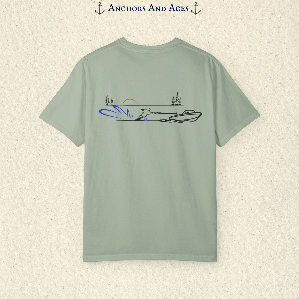 Bay Comfort Colors 1717 water ski shirt shown from the back, featuring minimalist line art of a ski boat pulling a slalom water skier across calm lake water at sunrise with pine trees and blue spray.