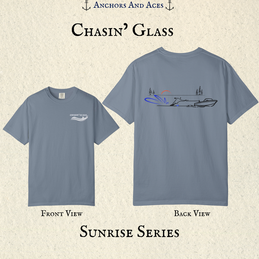 Blue Jean Comfort Colors 1717 water ski shirt shown from the front and back. Front features the white Chasin' Glass water-splash chest logo; back features minimalist line art of a ski boat pulling a slalom water skier at sunrise with pine trees and blue spray.