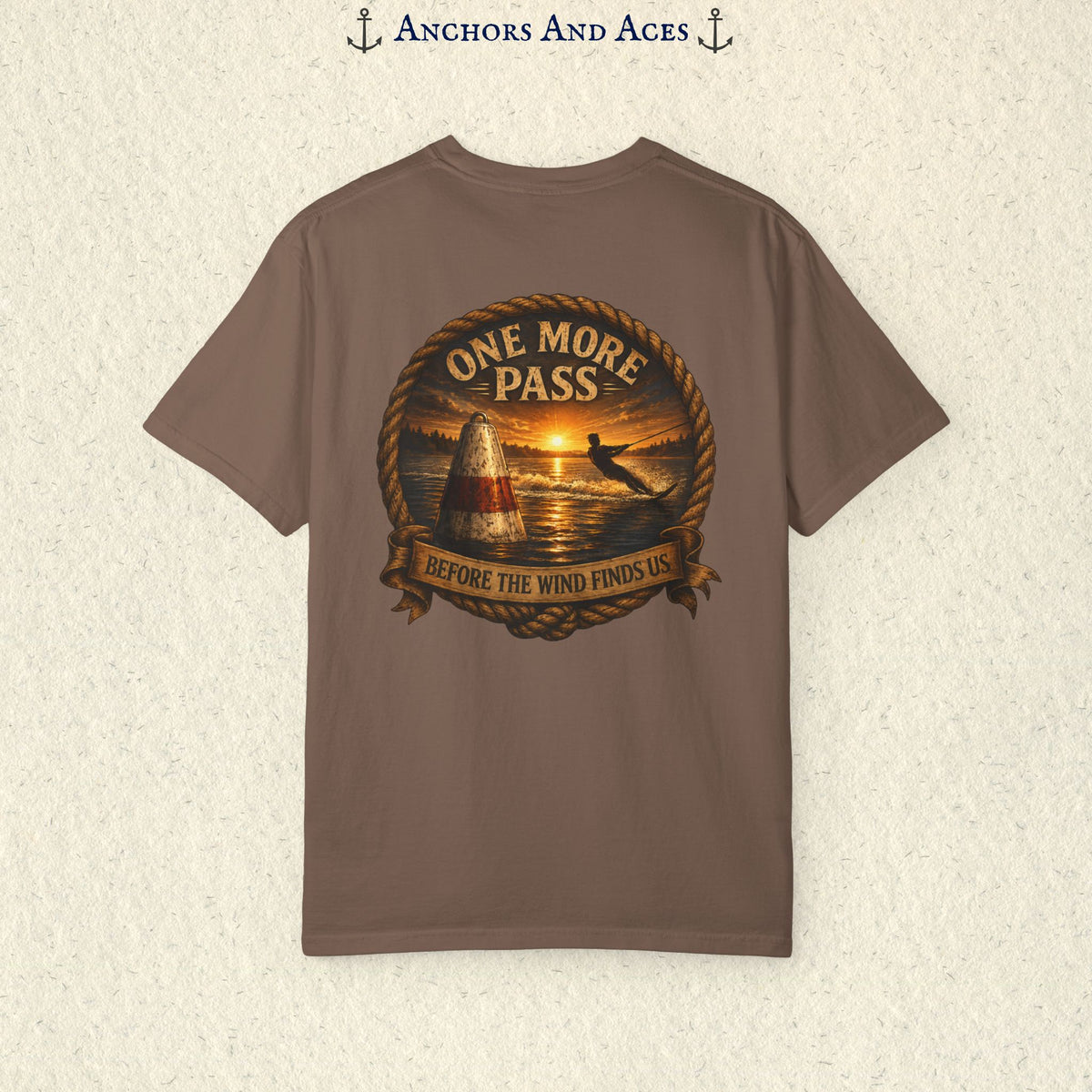 Espresso brown vintage slalom water ski T-shirt shown from the back with a sunrise lake graphic featuring a slalom buoy, water skier, rope border, and the text One More Pass and Before the Wind Finds Us.