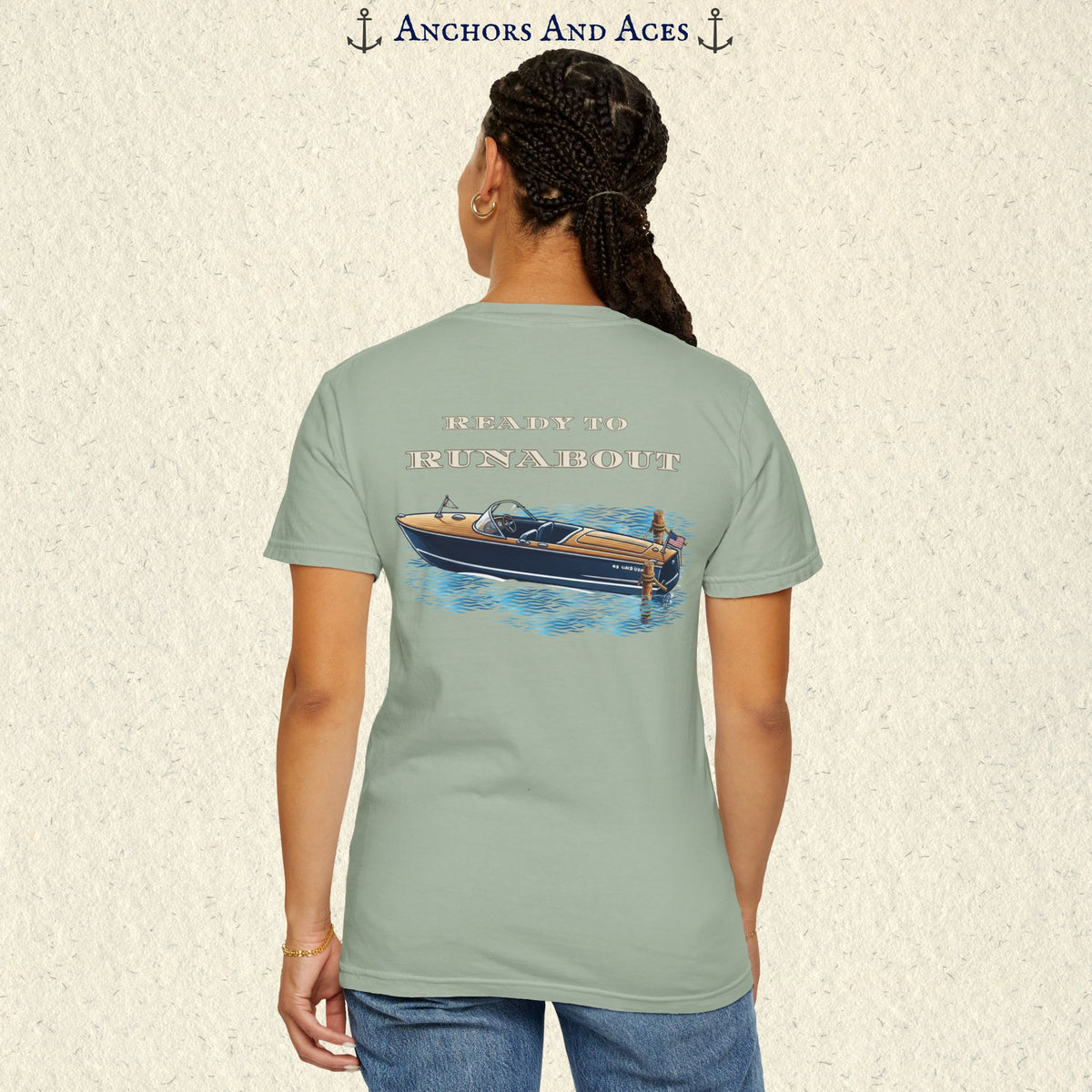 Model wearing a Bay classic wooden boat T-shirt from the back, featuring a vintage runabout on reflective blue water with Ready to Runabout text.
