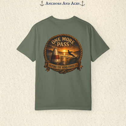 Moss green vintage slalom water ski T-shirt shown from the back with a sunrise lake graphic featuring a slalom buoy, water skier, rope border, and the text One More Pass and Before the Wind Finds Us.