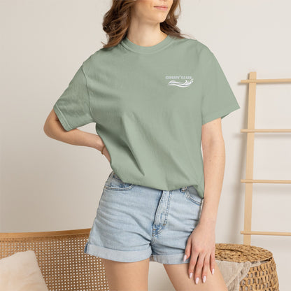 Model wearing a Bay Comfort Colors 1717 water ski t-shirt from the front, showing the small white Chasin' Glass water-splash logo on the left chest.