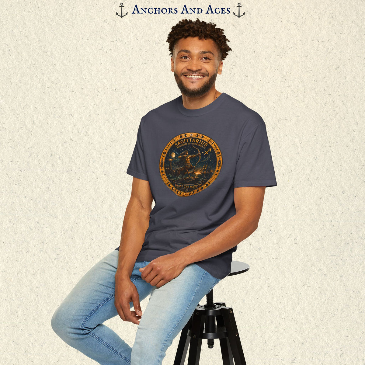 Male model seated wearing the Sagittarius Zodiac Shirt featuring the circular celestial archer artwork on the front.