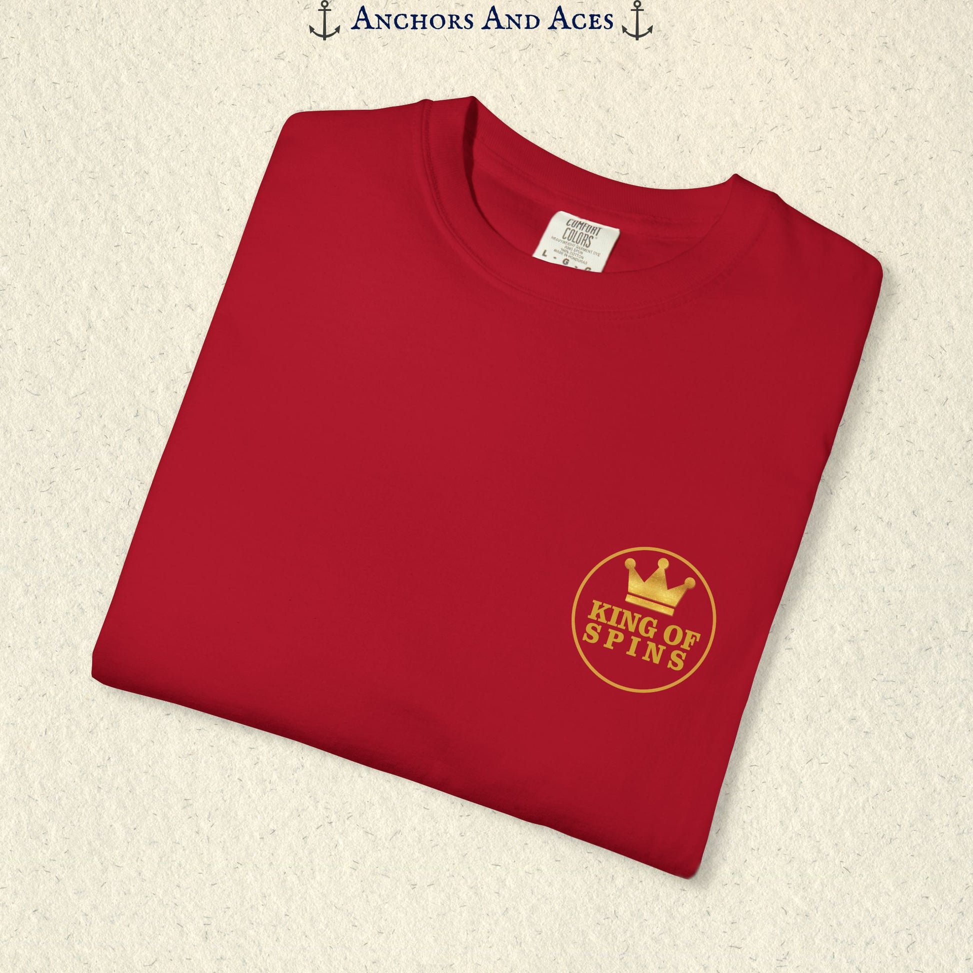 Folded Red Slot King T-shirt showing the small gold King of Spins chest emblem.