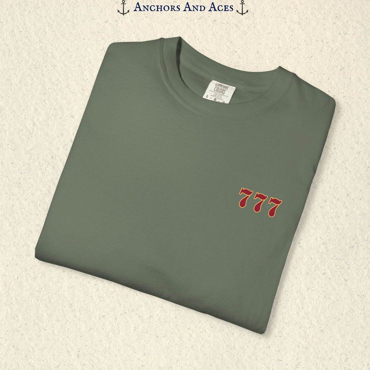 Folded Moss Lucky 777s T-shirt showing the small red 777 casino emblem on the front chest.