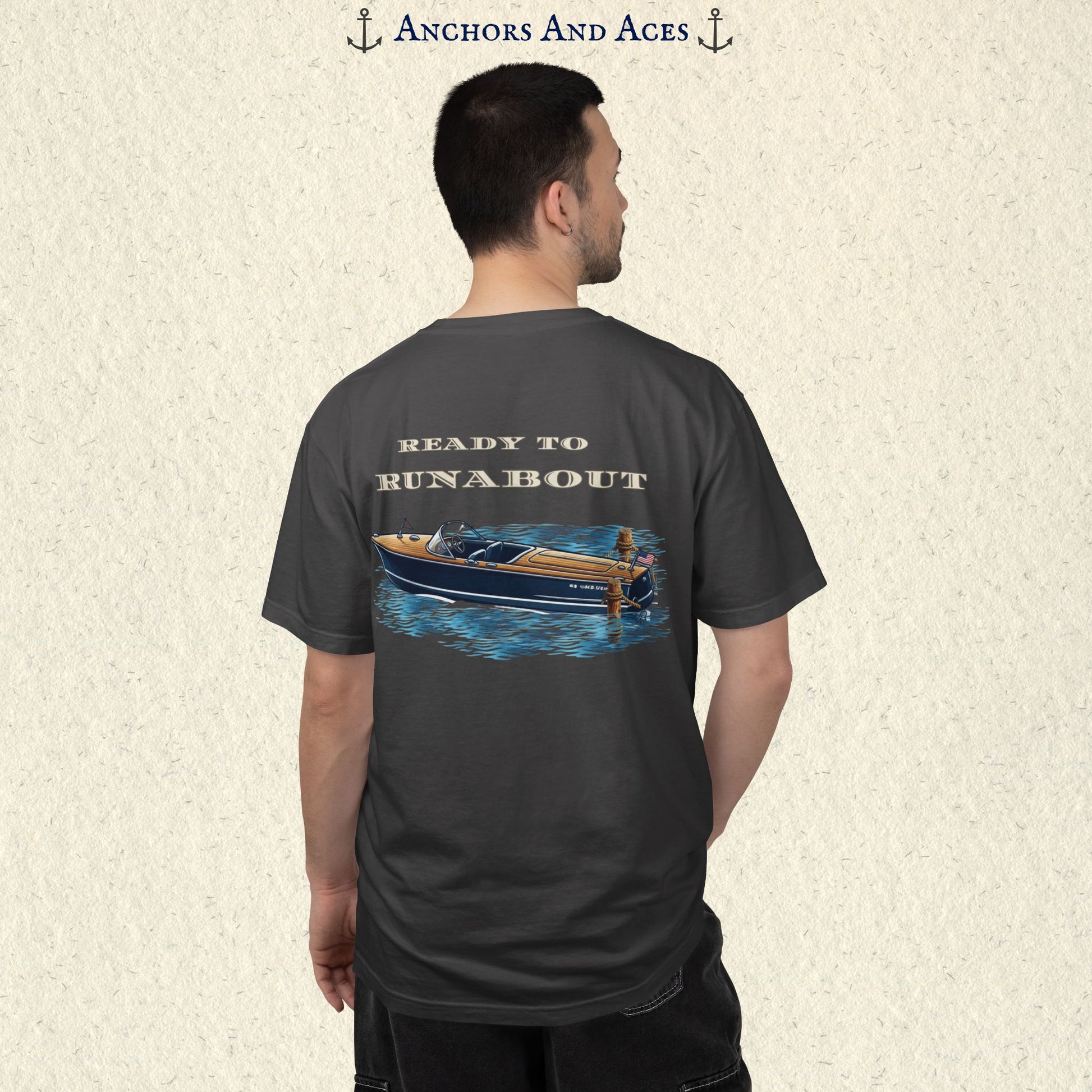 Model wearing a Graphite classic wooden boat T-shirt from the back, featuring a vintage runabout on reflective blue water with Ready to Runabout text.