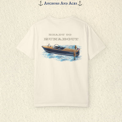 Ivory classic wooden boat T-shirt shown from the back, featuring a vintage runabout on reflective blue water with Ready to Runabout text above the boat.