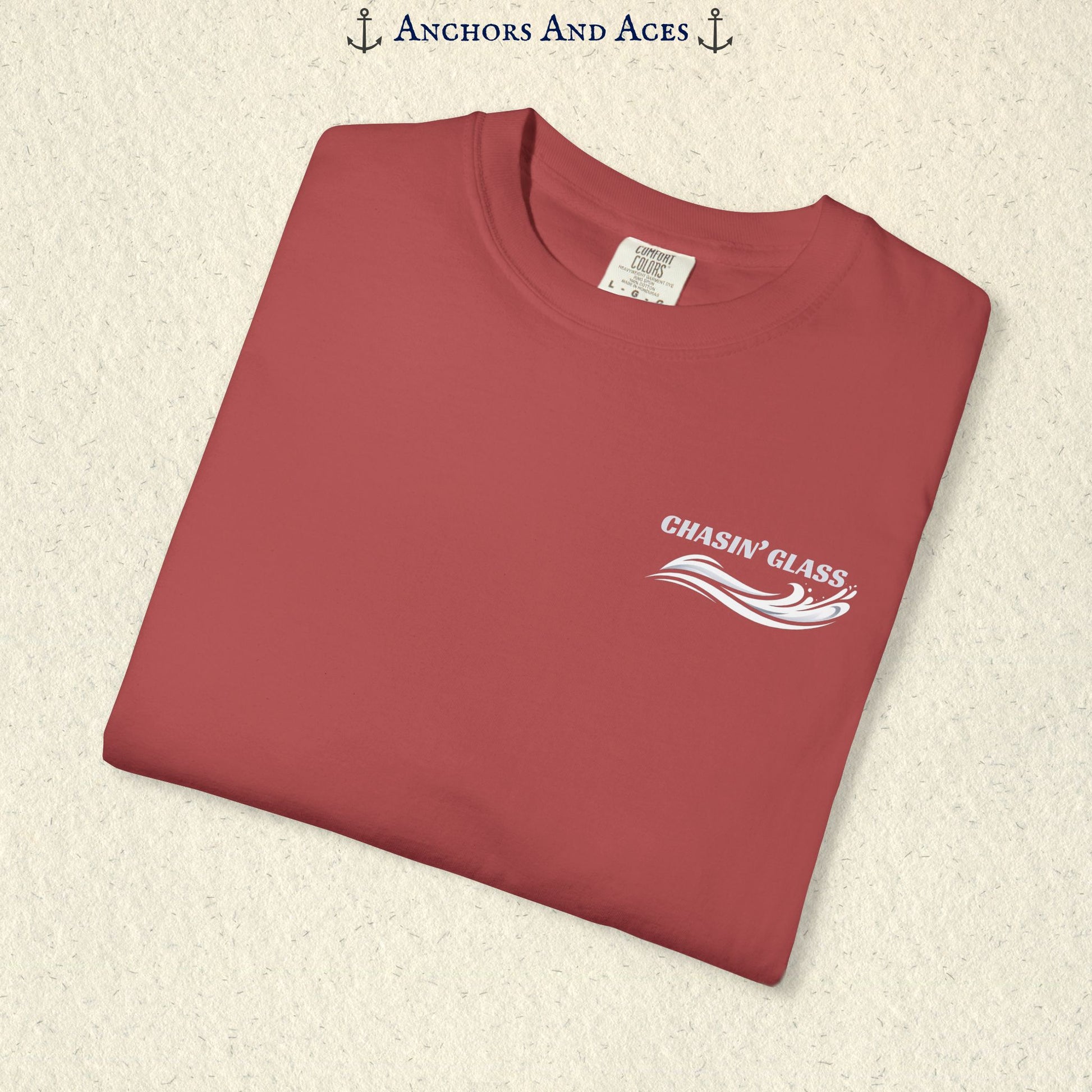 Folded Crimson Comfort Colors 1717 t-shirt showing the front left-chest Chasin' Glass logo, featuring white lettering above a stylized water-splash graphic.