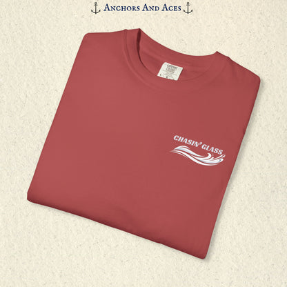 Folded Crimson Comfort Colors 1717 t-shirt showing the front left-chest Chasin' Glass logo, featuring white lettering above a stylized water-splash graphic.