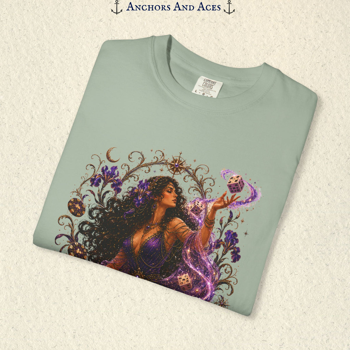 Close-up of Goddess of Chance Art Nouveau graphic on Light Green Comfort Colors tee with illustrated goddess, dice, irises, and gold filigree.