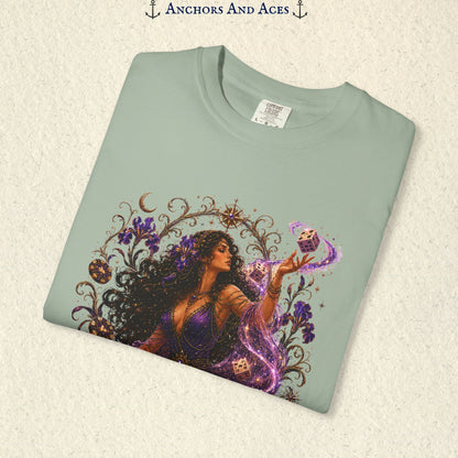 Close-up of Goddess of Chance Art Nouveau graphic on Light Green Comfort Colors tee with illustrated goddess, dice, irises, and gold filigree.