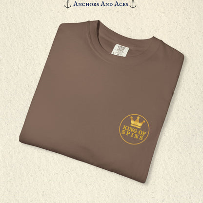 Folded Espresso Slot King T-shirt showing the small gold King of Spins chest emblem.