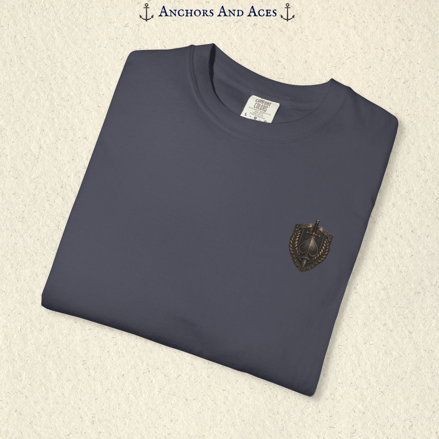 Folded House of Spades playing card shirt showing the small coordinating heraldic crest emblem on the front.