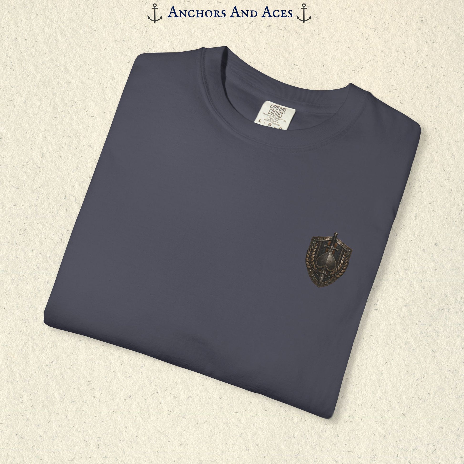 Folded House of Spades playing card shirt showing the small coordinating heraldic crest emblem on the front.