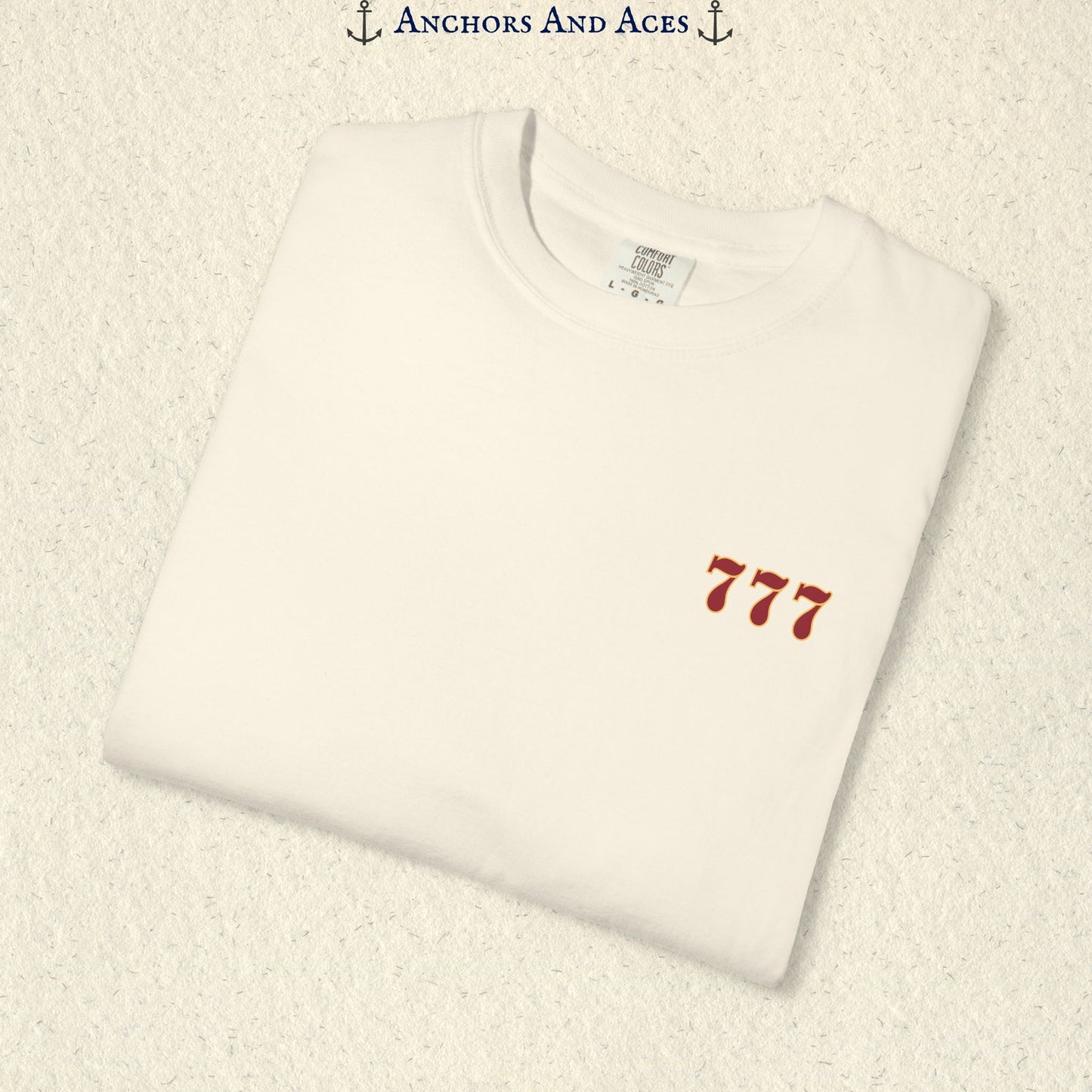 Folded Ivory Lucky 777s T-shirt showing the small red 777 casino emblem on the front chest.