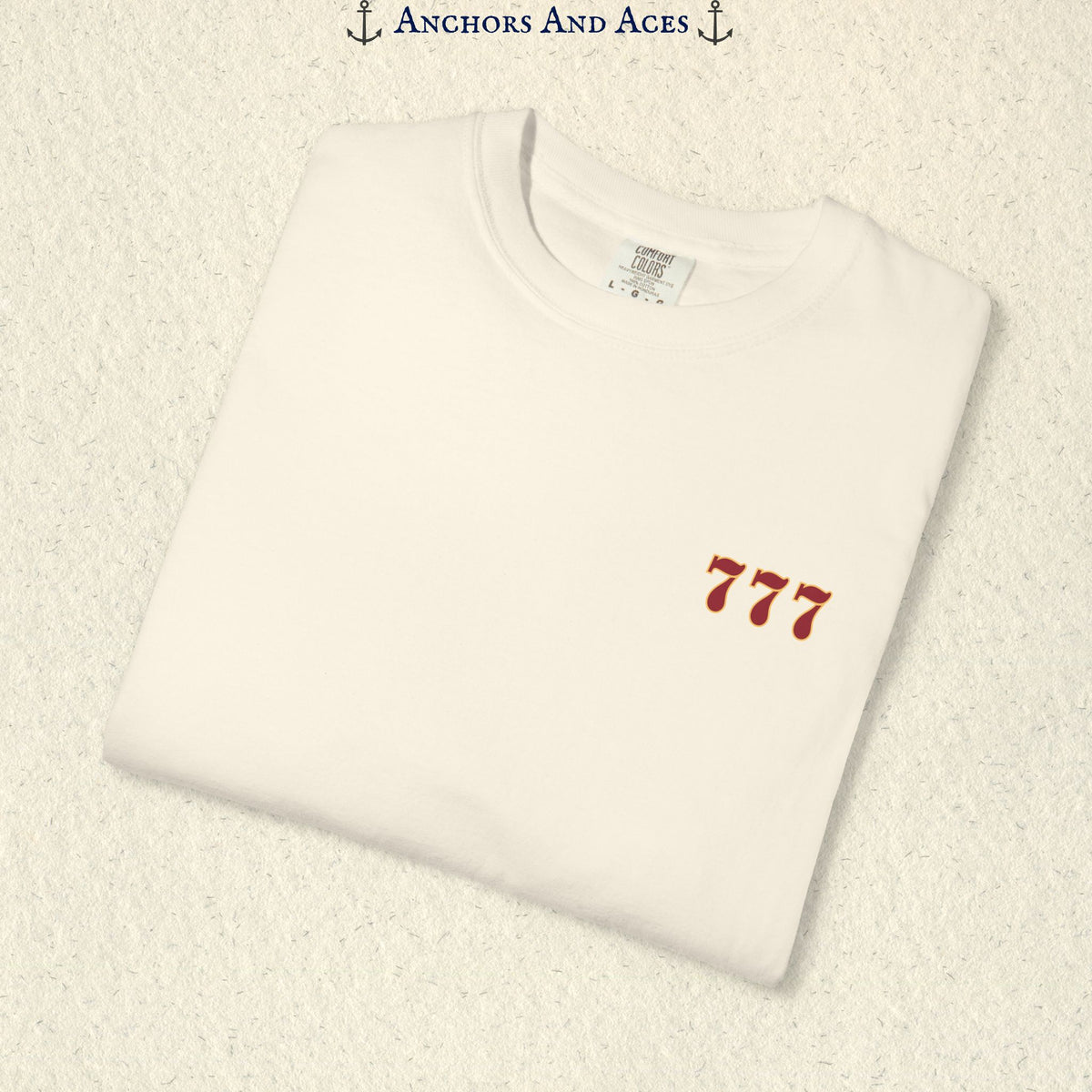 Folded Ivory Lucky 777s T-shirt showing the small red 777 casino emblem on the front chest.