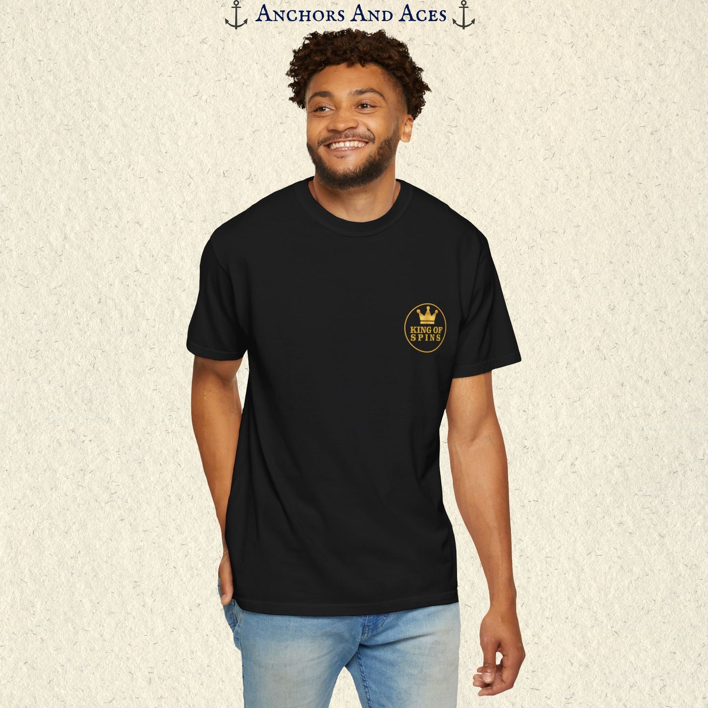 Man wearing a Black Slot King T-shirt with the small gold King of Spins emblem on the front.